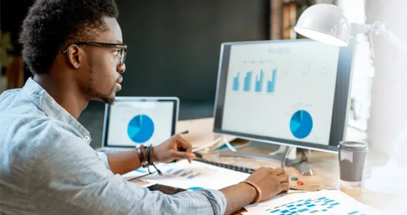 Data Analytics Student Analyzing Graphs on Computer